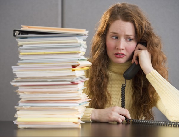 Overworked woman in cubicle.