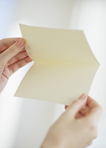 Hands opening a blank card.
