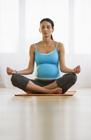 Pregnant woman meditating.