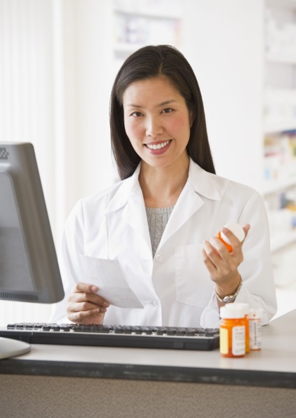 Pharmacist holding prescription medication.