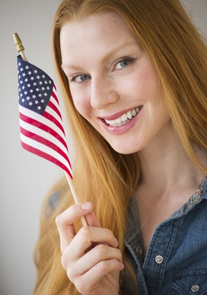 Woman holding American flag.