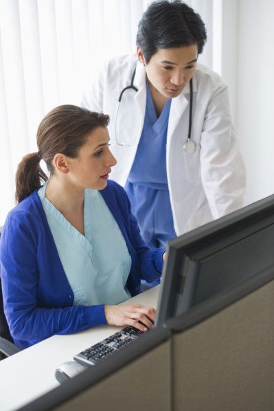 Doctor and nurse looking at computer.
