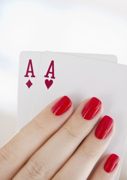 Hand holding a pair of aces.
