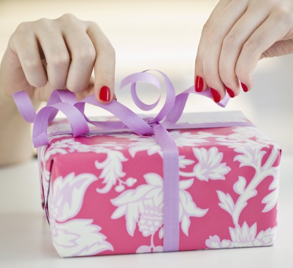Tying a bow on a present.