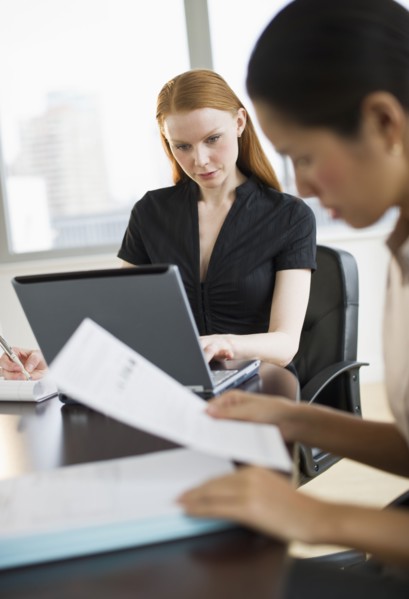 Businesswomen working in conference room.
