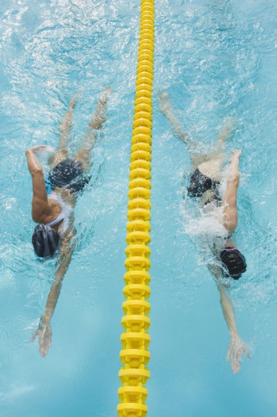 Women swimming laps in pool.