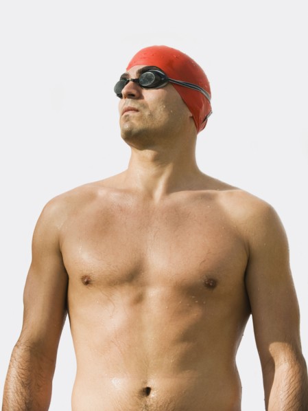 Man wearing bathing cap and swimming goggles.