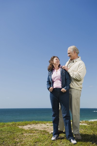 Couple standing near the ocean.
