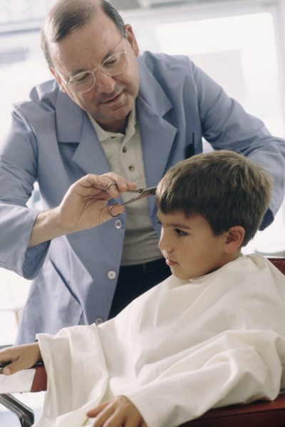 Young boy getting a haircut. Photographe : Rob Lewine