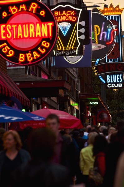 Crowd of people and Illuminated signs on Beale Street.