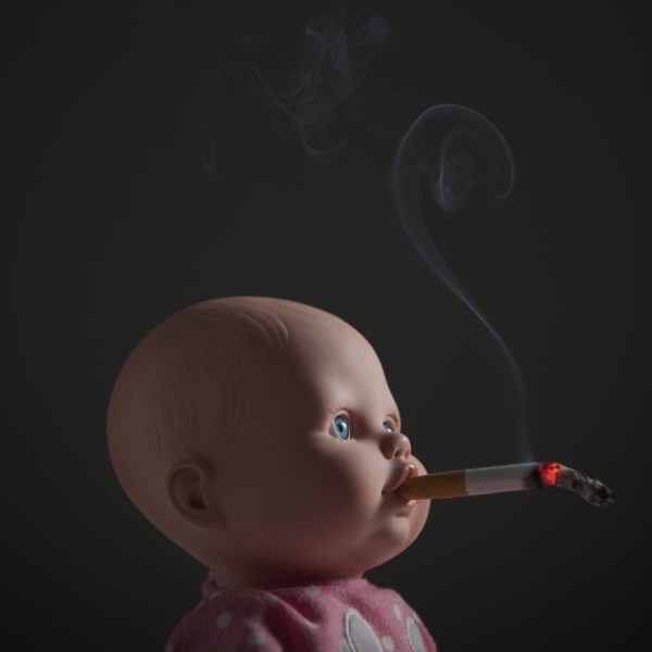 Cigarette in doll's mouth. Photo : Mike Kemp