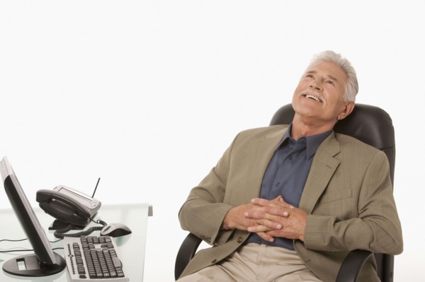 Businessman relaxing at his desk. Photo : K.Hatt