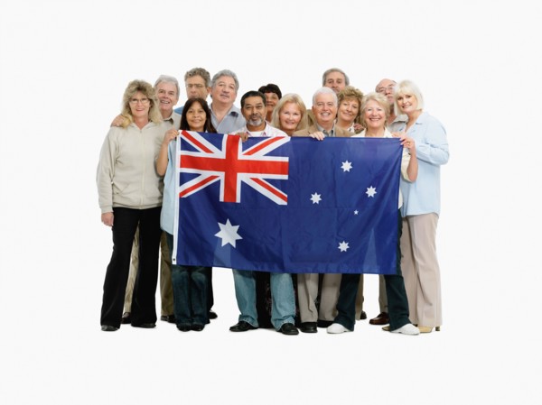 Group of people holding an Australian flag. Photo : momentimages