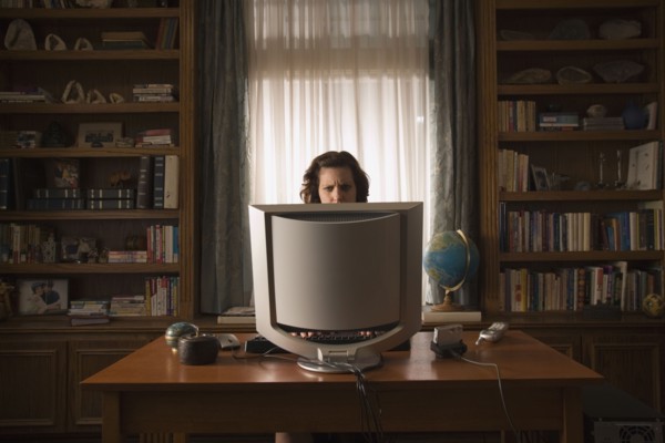 Woman sitting at desk in home office. Photo : Stewart Cohen