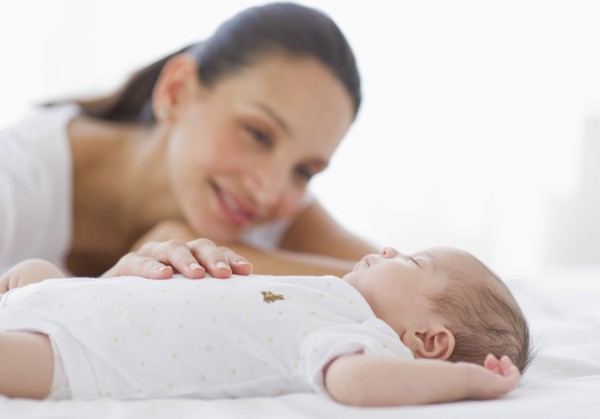 Mother watching her baby sleep.