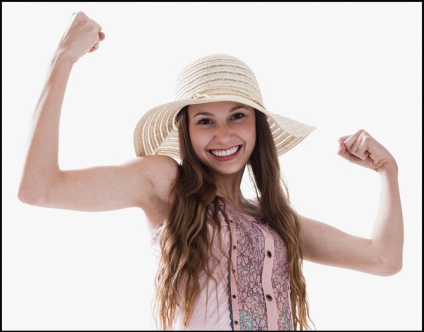 Smiling woman flexing her muscles. Photo : Mike Kemp