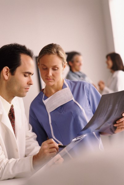Doctor and nurse looking at chart. Photo : Rob Lewine