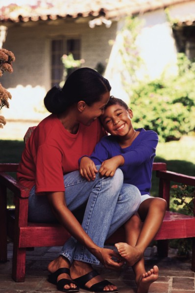 Mother and daughter sitting on bench in garden. Photo : Rob Lewine