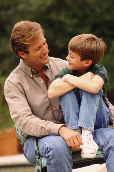 Father and son sitting outside together. Photo : Rob Lewine