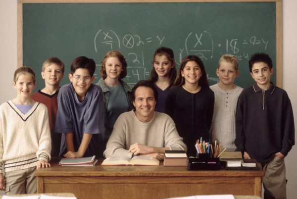 Elementary school students standing behind teacher. Photo : Rob Lewine