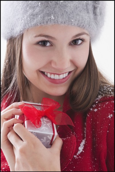 Woman holding small Christmas present. Photo : Mike Kemp