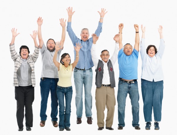 A group of people jumping with their arms raised. Photo : momentimages