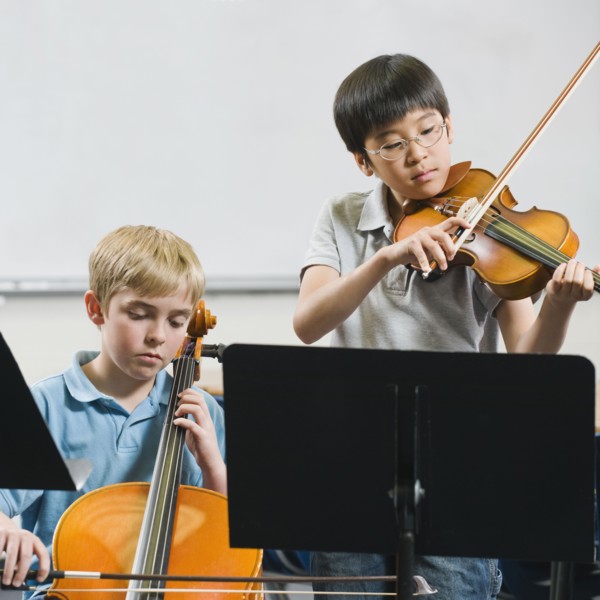 Elementary school students playing instruments in music class.