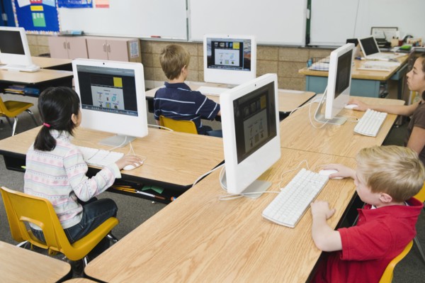 Children working at computers in classroom.