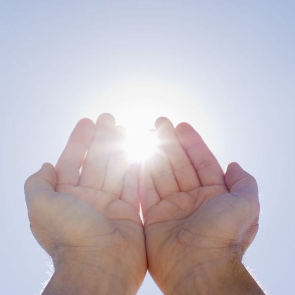 Hands framing sunshine.