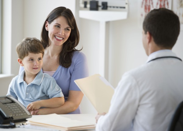 Doctor talking to woman and her son.