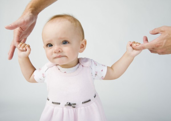 Baby holding father`s fingers. Photo. Erik Isakson