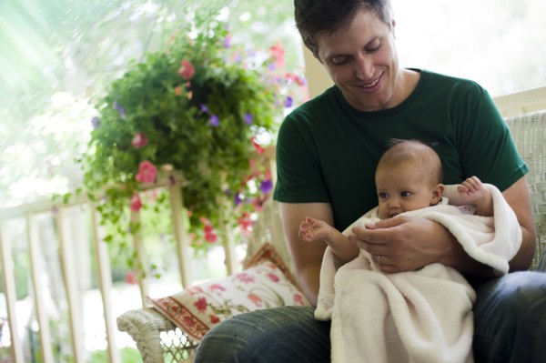 Father sitting on porch with his baby daughter. Photo. Tim Pannell
