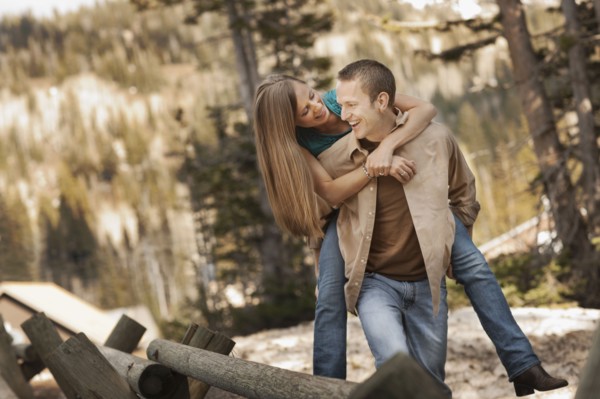 Man giving girlfriend a piggyback ride. Photo. FBP