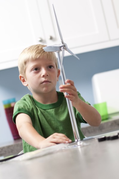 Little boy looking at model windmill. Photo. Tim Pannell