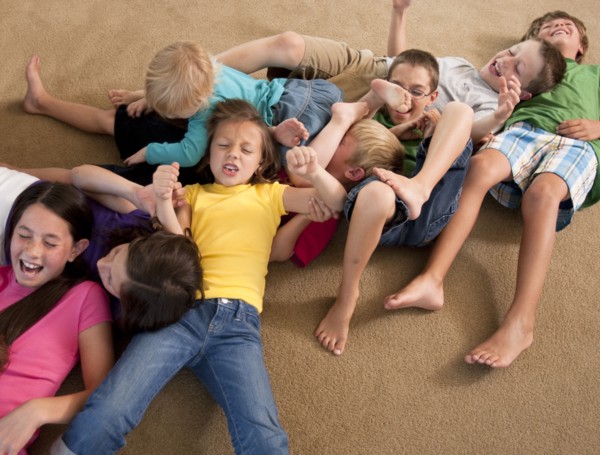 Group of children playing on floor. Photo : Tim Pannell