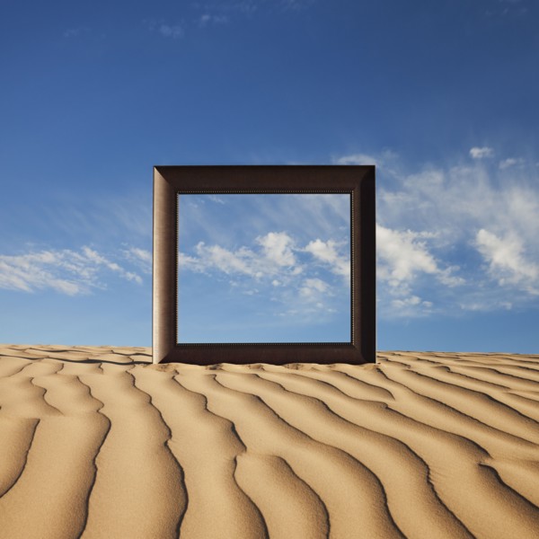 Picture frame on desert sand. Photo. Mike Kemp