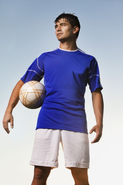 Soccer player holding ball. Photo : Mike Kemp