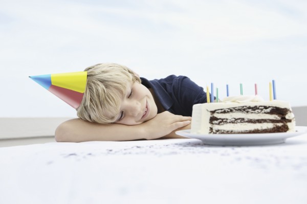 Young boy daydreaming about birthday cake. Photo. momentimages