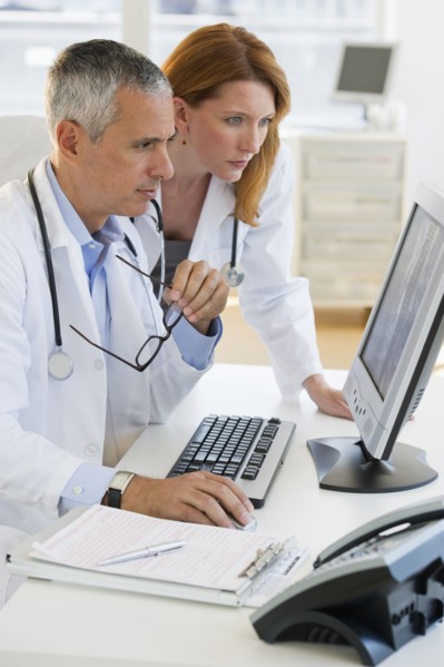 Healthcare professionals looking at computer.