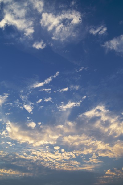 Clouds in blue sky at dusk.