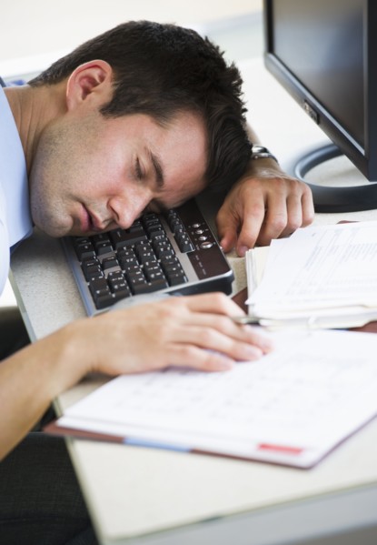 Businessman asleep at his desk.