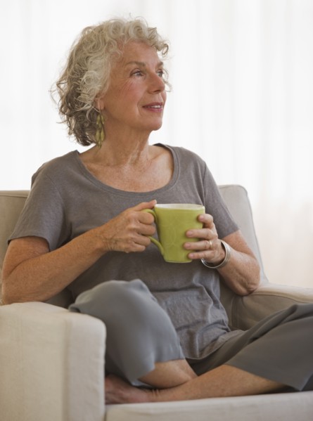 Woman drinking a cup of coffee. Photo. Daniel Grill