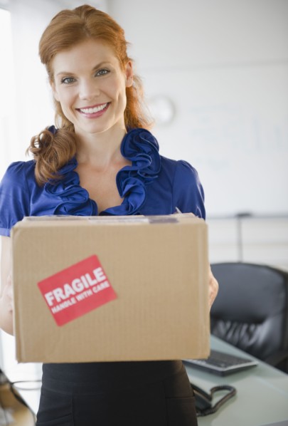 Businesswoman holding a package. Photo. Jamie Grill