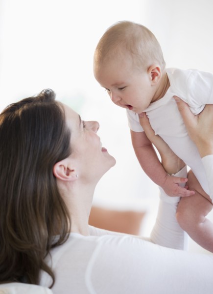 Mother playing with her baby.