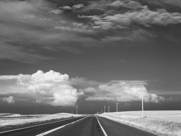 Dark sky over deserted highway. Photo : John Kelly