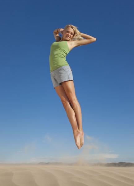 Woman jumping in the desert. Photo. Mike Kemp