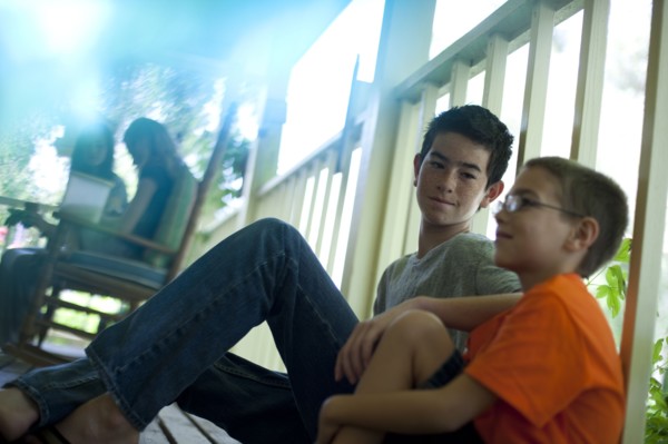Two young boys sitting on porch. Photo. Tim Pannell