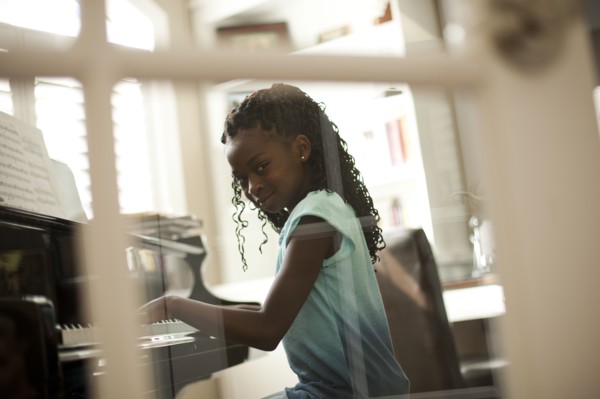Young girl playing piano. Photo. Tim Pannell