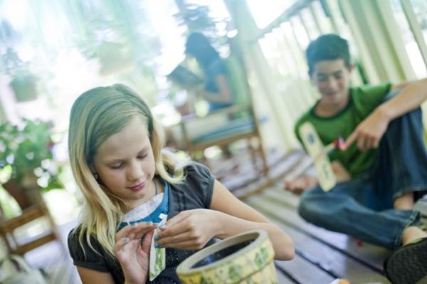 Young girl opening a seed packet. Photo : Tim Pannell