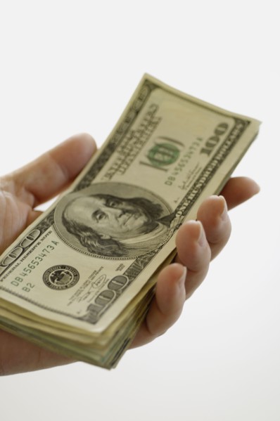 Hand holding money. Photo. Antonio M. Rosario